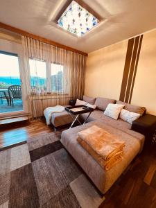 a living room with a couch and a window at Almblick in ruhiger Lage in Trahütten