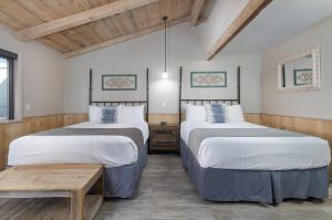 a room with two beds and a wooden ceiling at Sky Ranch Lodge in Sedona