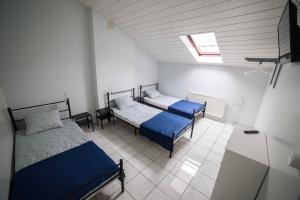 a bedroom with two beds and a skylight at Pokoje Jaśminowa in Lublin