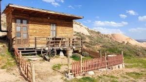 une cabane en bois avec une clôture devant elle dans l'établissement Ovadi Valley Houses, à Ürgüp