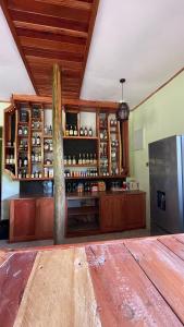 een bar met houten kasten en een koelkast bij Skill forest lodge in Arusha