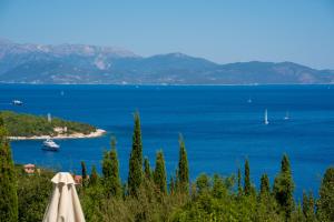 a view of a large body of water with a boat at Garden House, up to 8px 1km from Fiskardo in Tselendáta