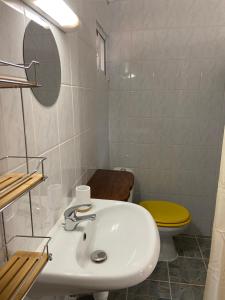 a white bathroom with a sink and a toilet at Joli studio 30m2 rte de St Jean tout confort 