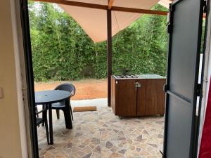 a view of a patio with a table and a stove at Joli studio 30m2 rte de St Jean tout confort 