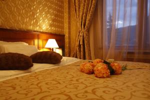a hotel room with a bed with flowers on it at Mountain Boutique Family Hotel in Devin
