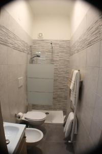 a bathroom with a toilet and a sink and a shower at Tiny House Bari in Bari