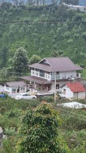 a large house with cars parked in front of it at Sandiago Villa 2 Bhk House - Only Bachelors Adults in Ooty