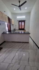a large kitchen with a ceiling fan in a room at Sandiago Villa 2 Bhk House - Only Bachelors Adults in Ooty