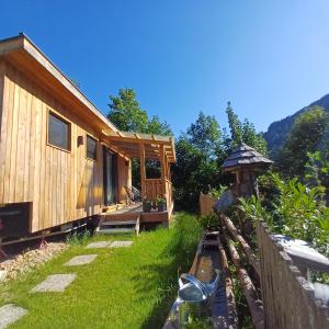 a wooden cabin in a yard next to a fence at Tiny House am Steinergut in Radstadt