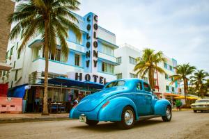 a blue truck parked in front of a hotel at Colony Hotel in Miami Beach