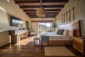 a bedroom with a large bed with a wooden ceiling at Emmalu Hotel Boutique in San Marcos