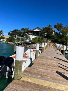 a boat is docked next to a dock at Harbour Beach Villa - large dock & great views! in Marsh Harbour