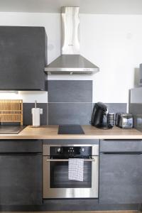 a kitchen with a stainless steel stove top oven at Joli nid douillet proche Nîmes in Bouillargues +17 photos