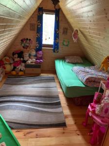 a small room with two beds in a attic at Całoroczny Domek Oliwia DELUX na wyłączność in Lubiatowo