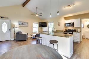 an open kitchen and living room with a counter top at St Cloud Vacation Rental - Walk to Lakefront Park! in Saint Cloud