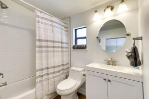 a bathroom with a toilet and a sink and a mirror at St Cloud Vacation Rental - Walk to Lakefront Park! in Saint Cloud +22 photos