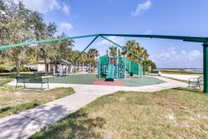 a playground with two benches in a park at St Cloud Vacation Rental - Walk to Lakefront Park! in Saint Cloud