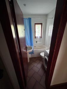 a bathroom with a tub and a toilet and a sink at Cal Tià in Viliella