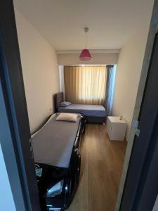 a small room with two beds and a window at Antalya apartment in Antalya