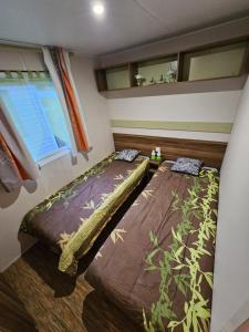 سرير أو أسرّة في غرفة في Magnifique Mobil home Lac D'Aiguebelette