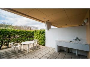 a patio with a sink and a table and chairs at Bokkai Onsen Seaside Villa Bokkai - Vacation STAY 69010v in Shika