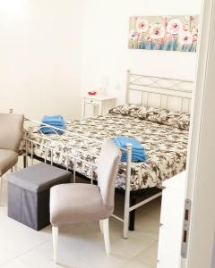 a bedroom with a bed and a table and chairs at Torre Camarda in Bernalda