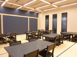 a classroom with tables and chairs and a chalkboard at Bokkai Onsen Seaside Villa Bokkai - Vacation STAY 69010v in Shika