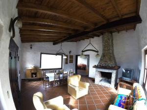a living room with a couch and a fireplace at La Escondida in Tafí del Valle