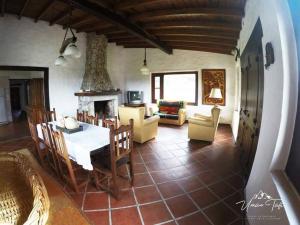 a living room with a table and a fireplace at La Escondida in Tafí del Valle