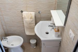a small bathroom with a sink and a toilet at Casa Terolì in Bari