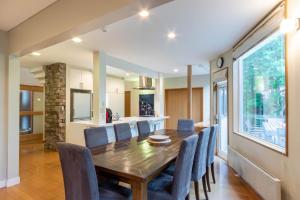 a dining room with a wooden table and blue chairs at Furano Chalet - Vacation STAY 14492 in Furano