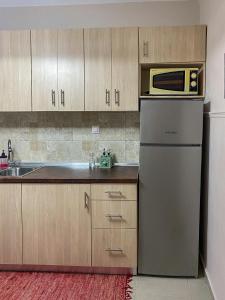 a kitchen with a refrigerator and a microwave at Medusa Beach Apartment, Asprovalta in Asprovalta