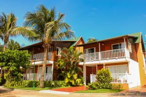 a house with palm trees in front of it at Decameron San Luis - All Inclusive in San Andrés