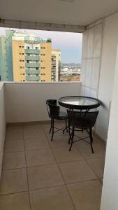 a table and chairs on a balcony with a view at Flat in Brasilia