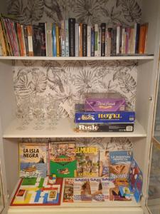 a book shelf filled with books and wine glasses at Hipica Home Granada Center in Granada