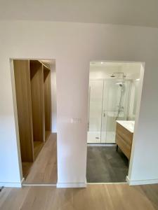 a white bathroom with a shower and a sink at Loft Rochegude in Albi