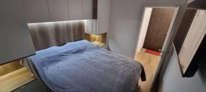 a small hospital room with a blue bed in it at Apartman BATI - Ravna Planina in Pale
