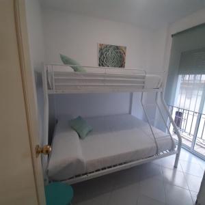 a white bunk bed in a room with a window at Piso en centro histórico in Jerez de la Frontera