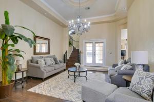 a living room with couches and a chandelier at Luxe Yuma Home with Private Pool! in Yuma