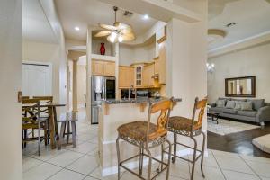 a kitchen and living room with a bar and chairs at Luxe Yuma Home with Private Pool! in Yuma