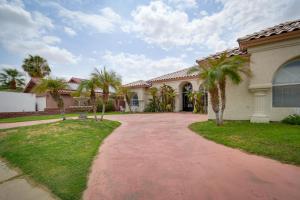a house with palm trees in the driveway at Luxe Yuma Home with Private Pool! in Yuma