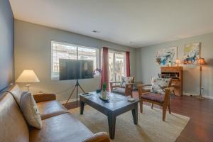 a living room with a couch and a coffee table at Charming Chapel Hill Townhome Near University! in Chapel Hill