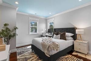 a bedroom with a large bed and a desk at Walkable Luxury Designer Home in Burlingame