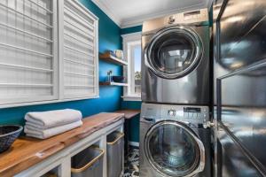 a laundry room with a washer and dryer in it at Walkable Luxury Designer Home in Burlingame
