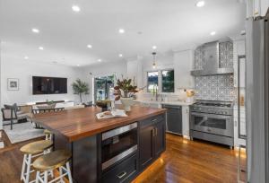 a kitchen with a wooden counter top and a kitchen island at Walkable Luxury Designer Home in Burlingame