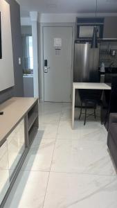 a kitchen with a table and a door and a table at Flat in Brasilia