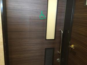 a wooden door with a green sign on it at Sun Hotel Tosu Saga - Vacation STAY 49480v in Tosu