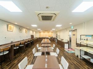 a dining room with tables and chairs and a cafeteria at Sun Hotel Tosu Saga - Vacation STAY 49480v in Tosu