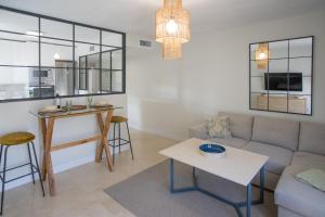 a living room with a couch and a table at Luxury Apartment Free Parking in Seville