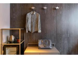 a coat hanging on a wooden wall with a bench at THE BOLY OSAKA - Vacation STAY 52833v in Osaka